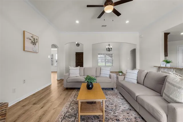 a living room with furniture and wooden floor