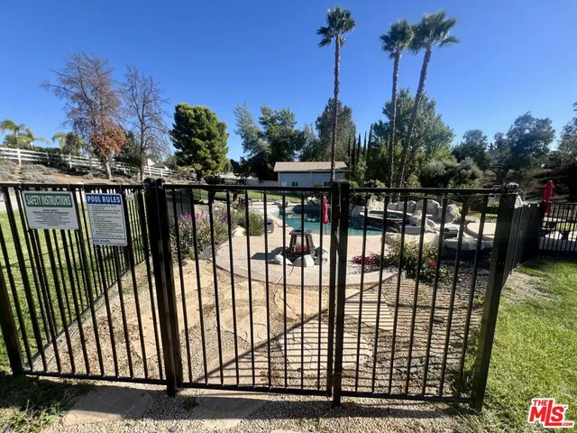 a view of a balcony with a floor to ceiling window and palm tree