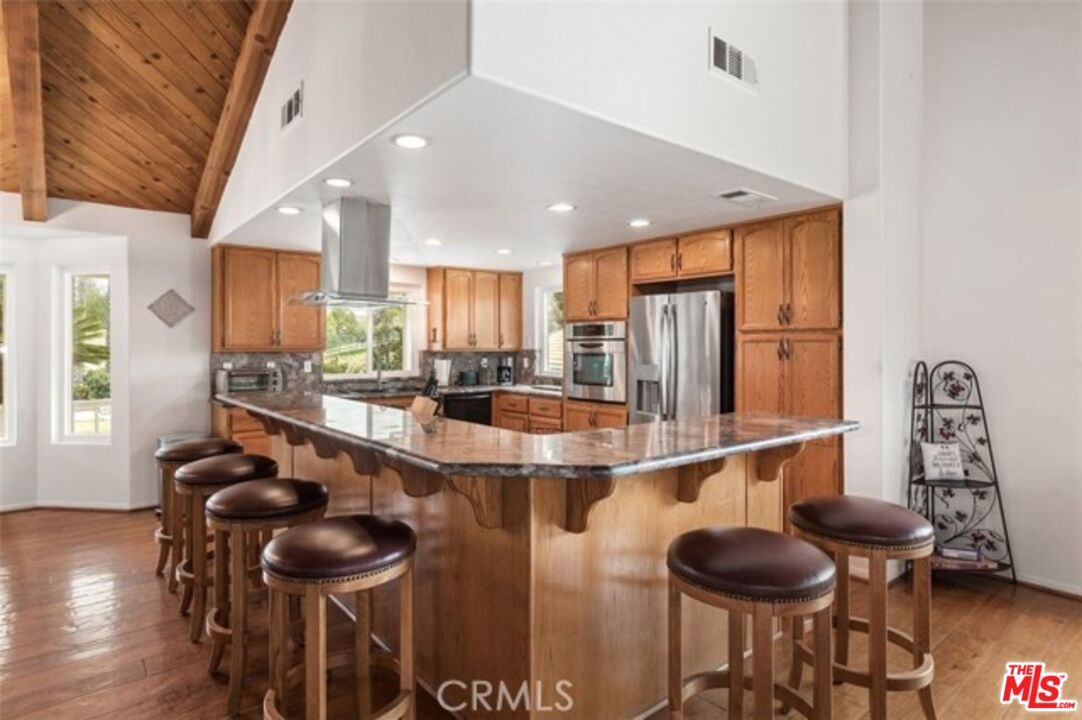37200 Glen Oaks Road, Unit 3 Temecula, CA 92592 - Photo 8 of 25 a kitchen with a table chairs and a refrigerator