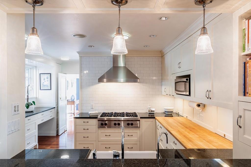 58 Randolph Road Brookline, MA 02467 - Photo 4 of 14 a kitchen with stainless steel appliances granite countertop a stove a sink and a refrigerator