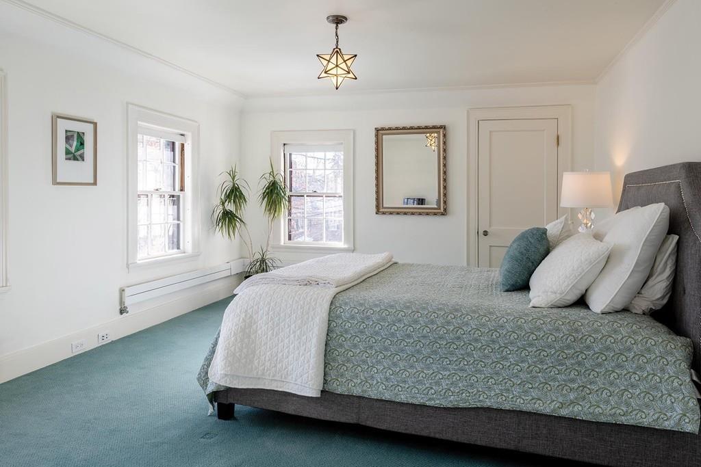 58 Randolph Road Brookline, MA 02467 - Photo 10 of 14 a bedroom with a large bed and wooden floor