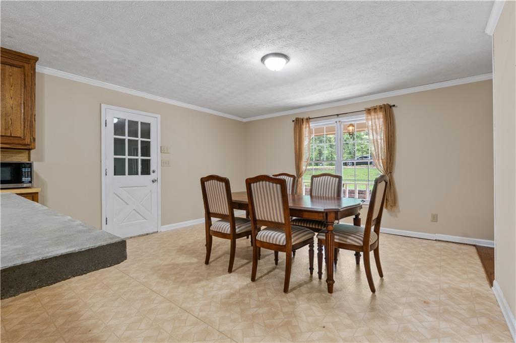 112 Brannon Road Buchanan, GA 30113 - Photo 19 of 40 a view of a dining room with furniture and a window