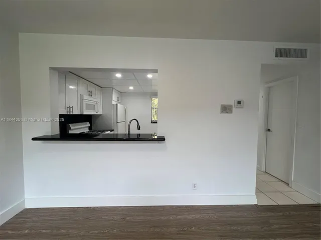 a view of kitchen with stainless steel appliances granite countertop refrigerator sink and stove