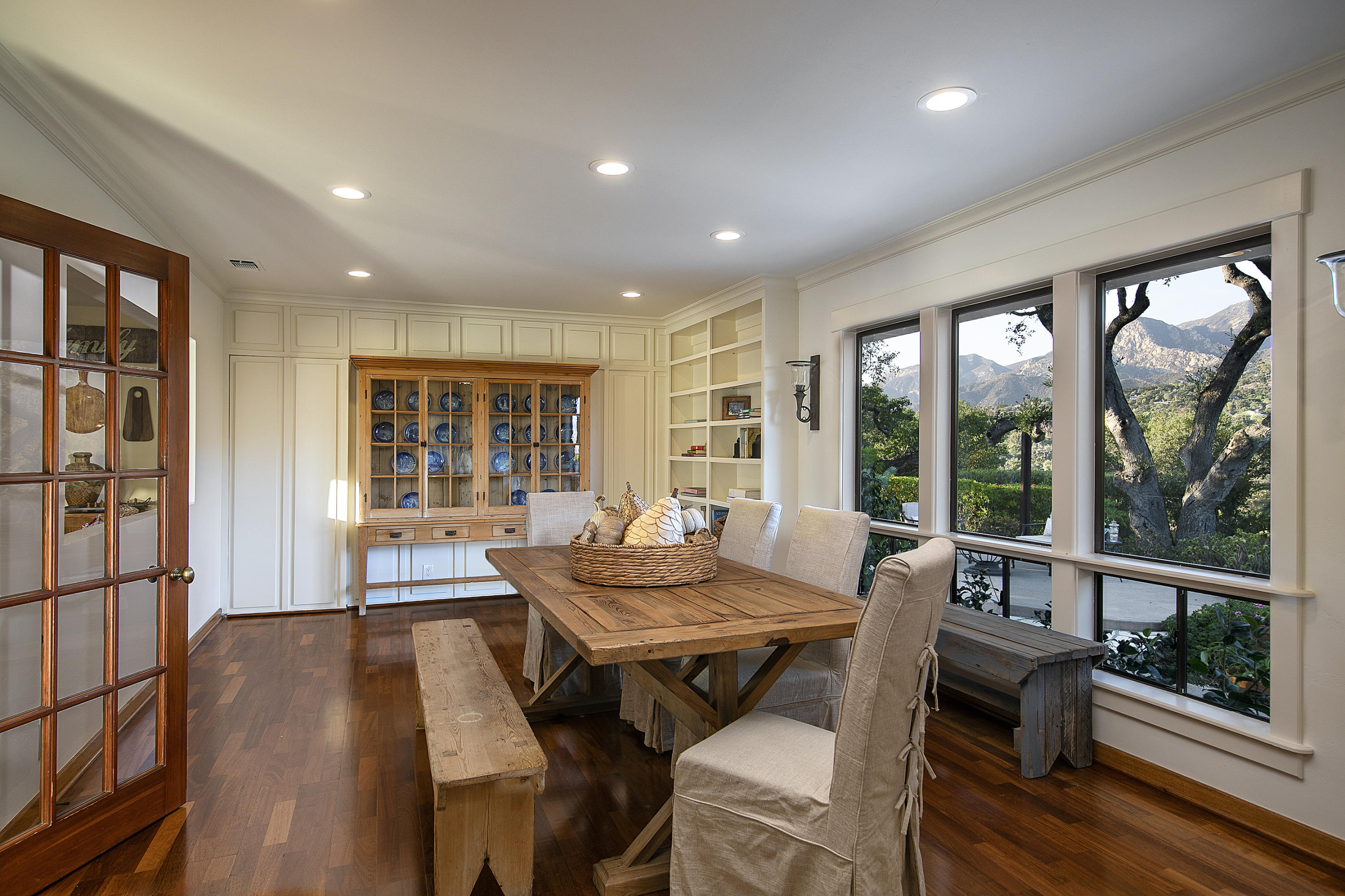 1025 Mission Ridge Road Santa Barbara, CA 93103 - Photo 6 of 10 a view of a dining room with furniture large windows and wooden floor