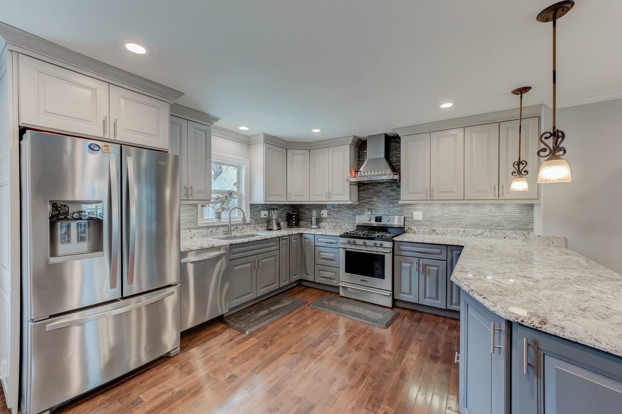 113 Saugatuck Road Montgomery, IL 60538 - Photo 2 of 19 a kitchen with granite countertop stainless steel appliances a refrigerator a stove top oven and sink