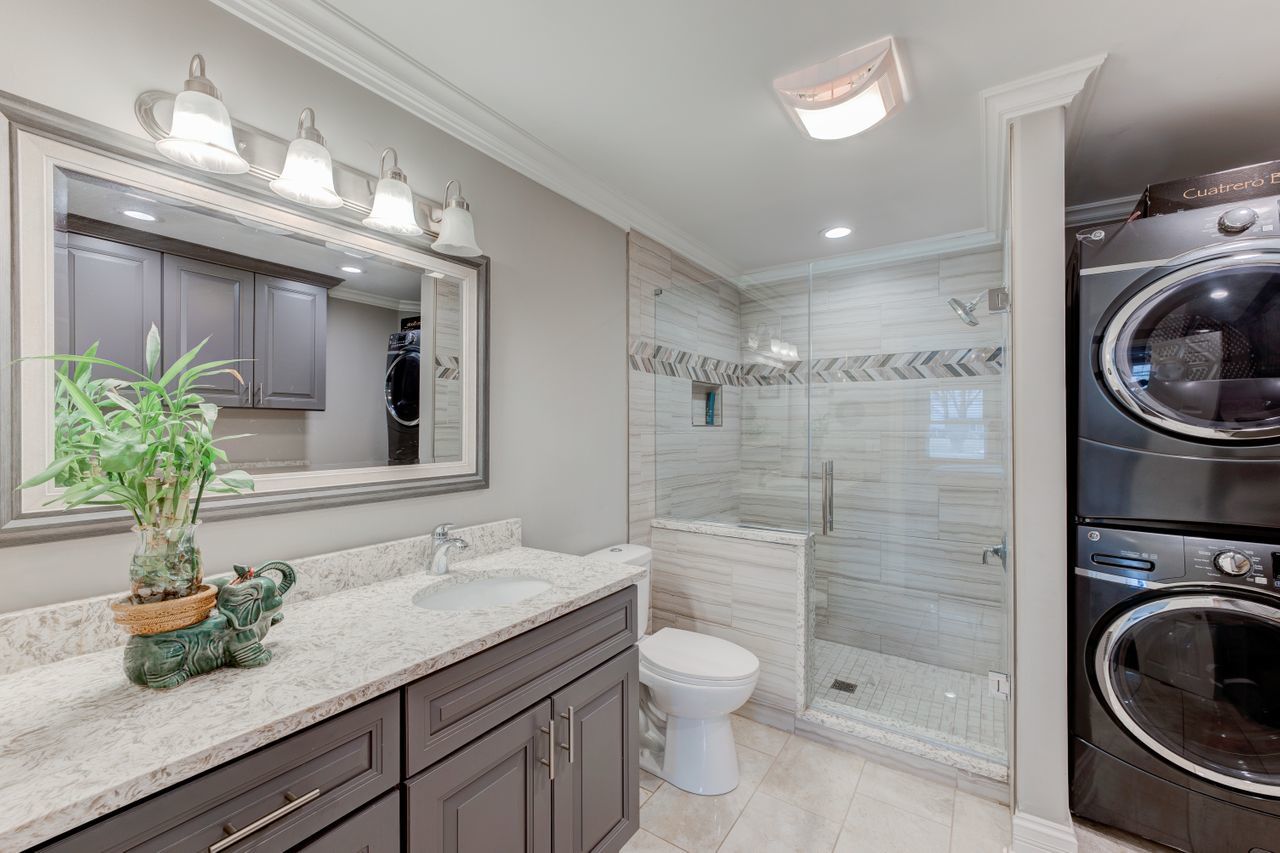 113 Saugatuck Road Montgomery, IL 60538 - Photo 13 of 19 a bathroom with a granite countertop sink a toilet and a shower