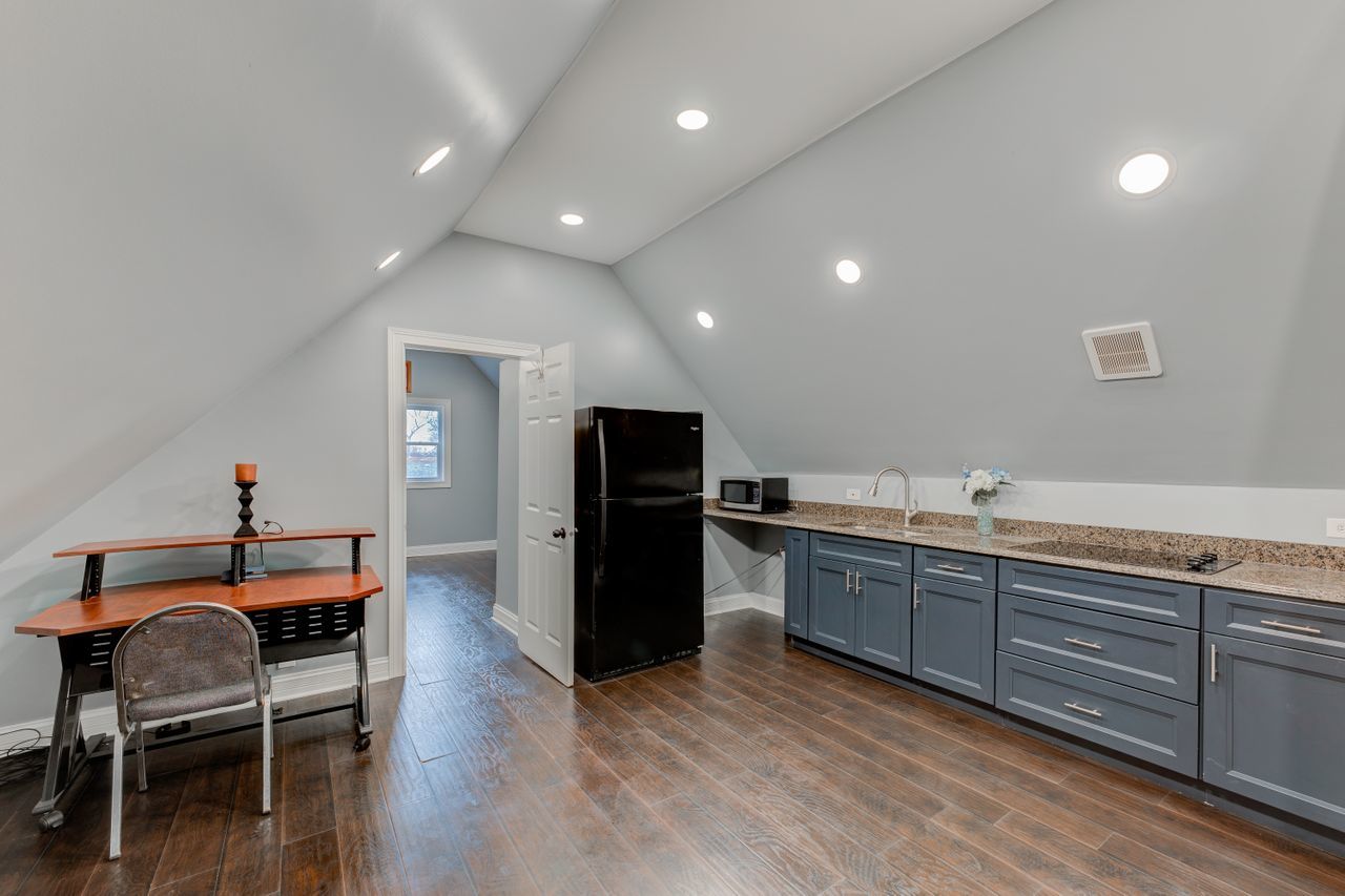113 Saugatuck Road Montgomery, IL 60538 - Photo 16 of 19 a kitchen with granite countertop wooden floors and chairs