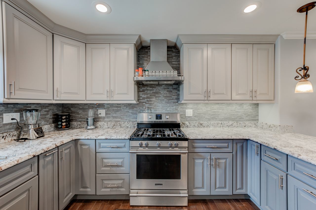113 Saugatuck Road Montgomery, IL 60538 - Photo 3 of 19 a kitchen with granite countertop white cabinets and stainless steel appliances