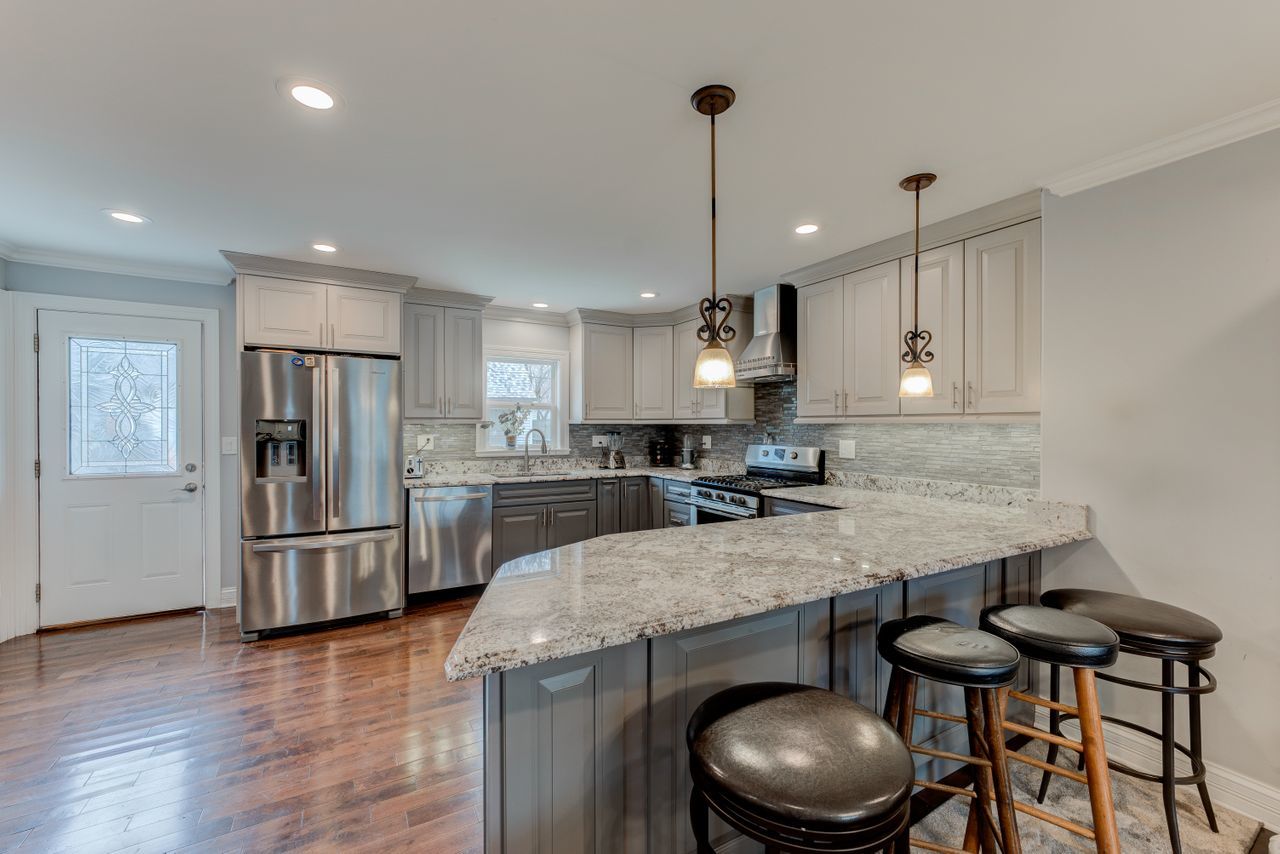 113 Saugatuck Road Montgomery, IL 60538 - Photo 4 of 19 a kitchen with stainless steel appliances granite countertop a sink a stove a refrigerator and chairs
