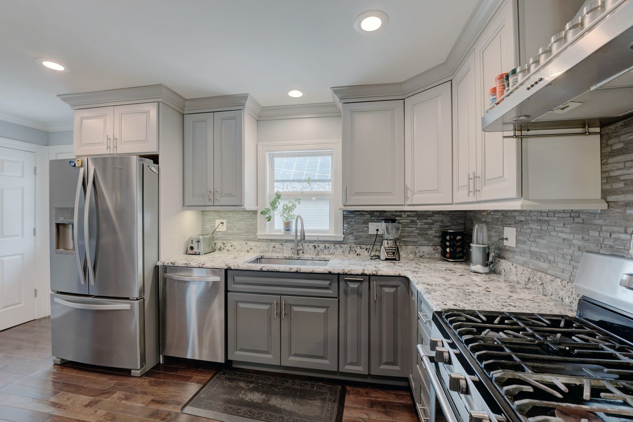 113 Saugatuck Road Montgomery, IL 60538 - Photo 5 of 19 a kitchen with stainless steel appliances granite countertop a stove a refrigerator and a sink