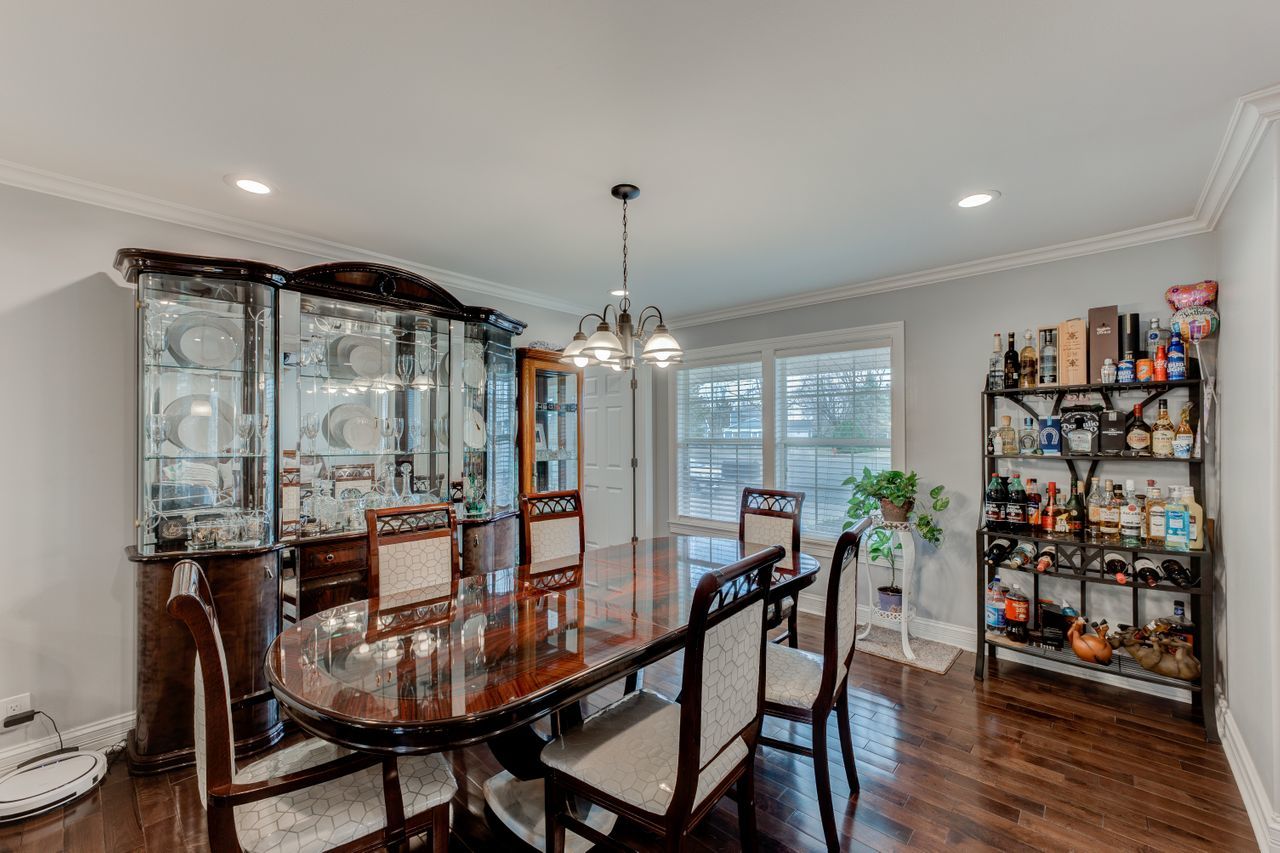113 Saugatuck Road Montgomery, IL 60538 - Photo 7 of 19 a dining room with furniture a chandelier and wooden floor