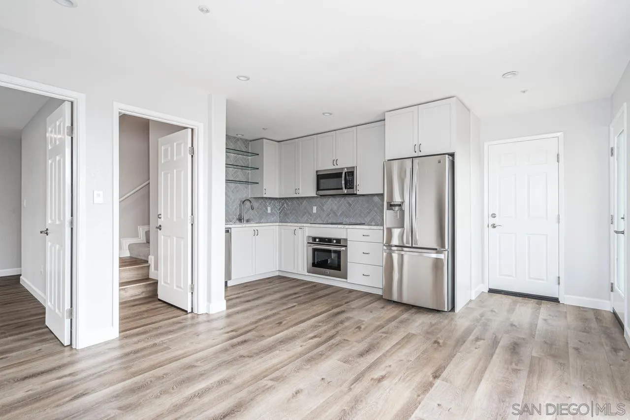 4310 Nabal Drive La Mesa, CA 91941 - Photo 20 of 20 a kitchen with a refrigerator a stove top oven and wooden floor