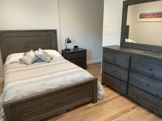a bedroom with a bed and a dresser