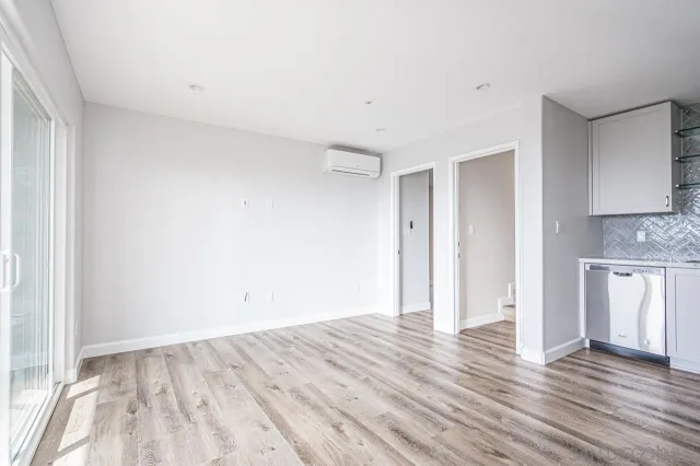 a view of a kitchen with wooden floor and a sink
