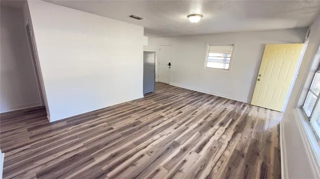 a kitchen with granite countertop a refrigerator stove and sink
