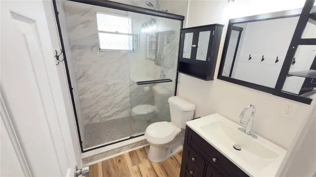 a view of a room with wooden floor and white wall