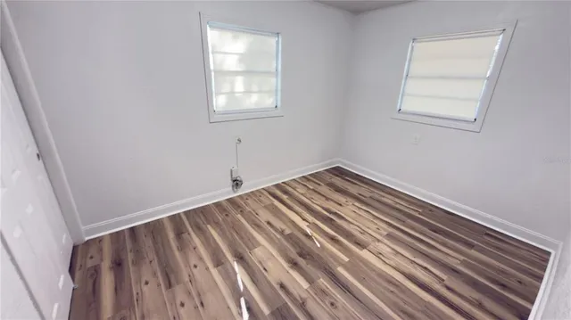a view of a room with wooden floor and closet