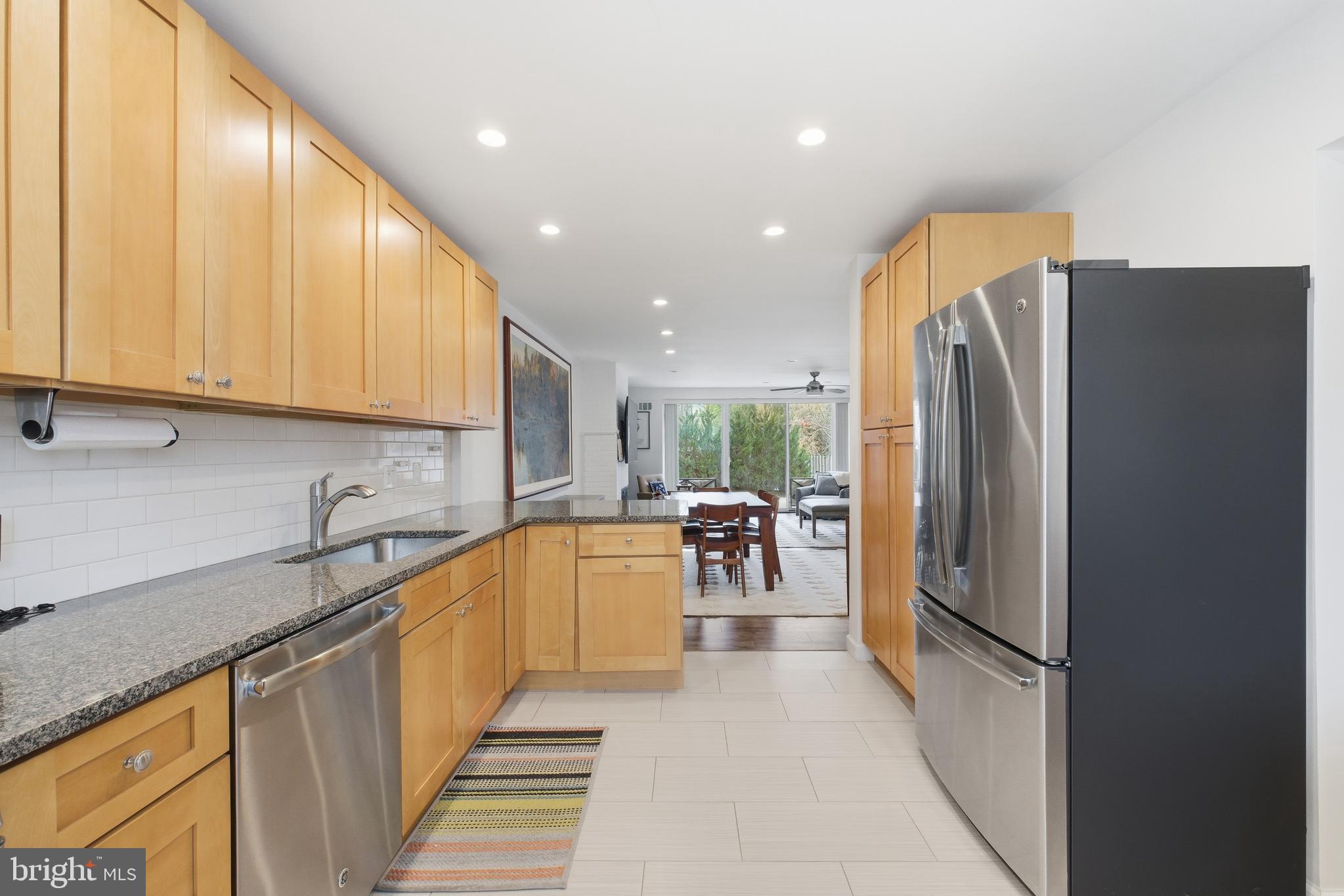 4848 Reservoir Road Northwest Washington, DC 20007 - Photo 14 of 49 a kitchen with stainless steel appliances granite countertop a refrigerator a sink and a stove