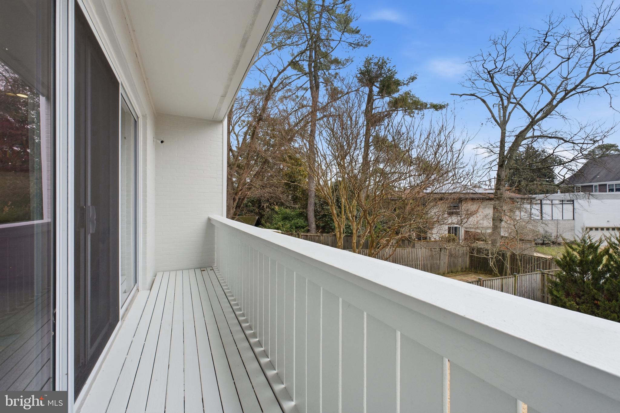 4848 Reservoir Road Northwest Washington, DC 20007 - Photo 19 of 49 a view of a balcony with wooden floor and fence