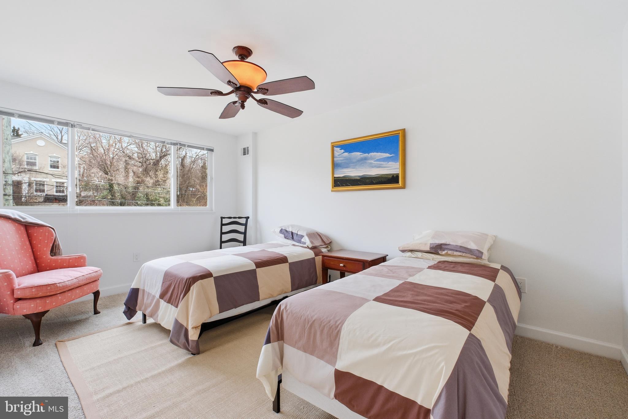 4848 Reservoir Road Northwest Washington, DC 20007 - Photo 22 of 49 a bedroom with two beds and a chandelier