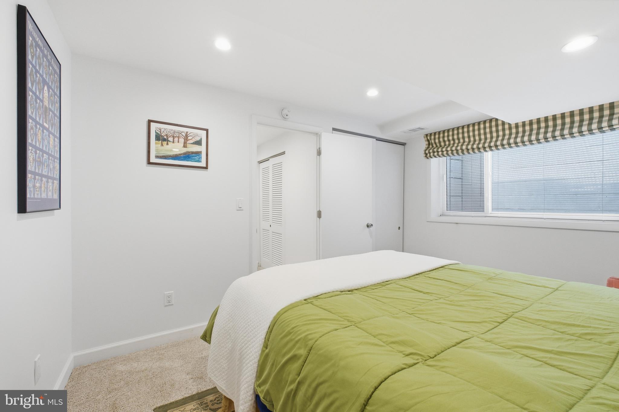 4848 Reservoir Road Northwest Washington, DC 20007 - Photo 29 of 49 a bedroom with a bed and a window