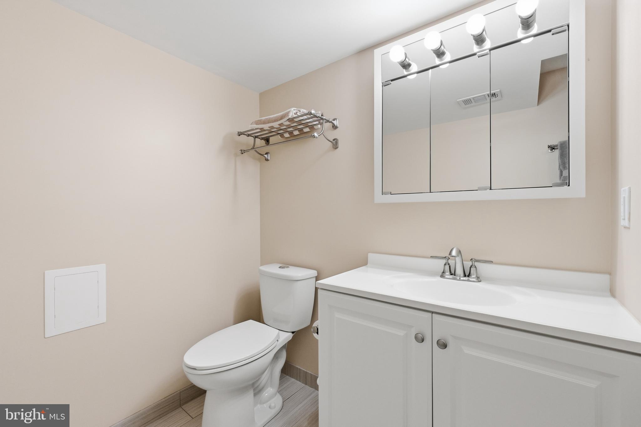 4848 Reservoir Road Northwest Washington, DC 20007 - Photo 30 of 49 a bathroom with a toilet sink and mirror