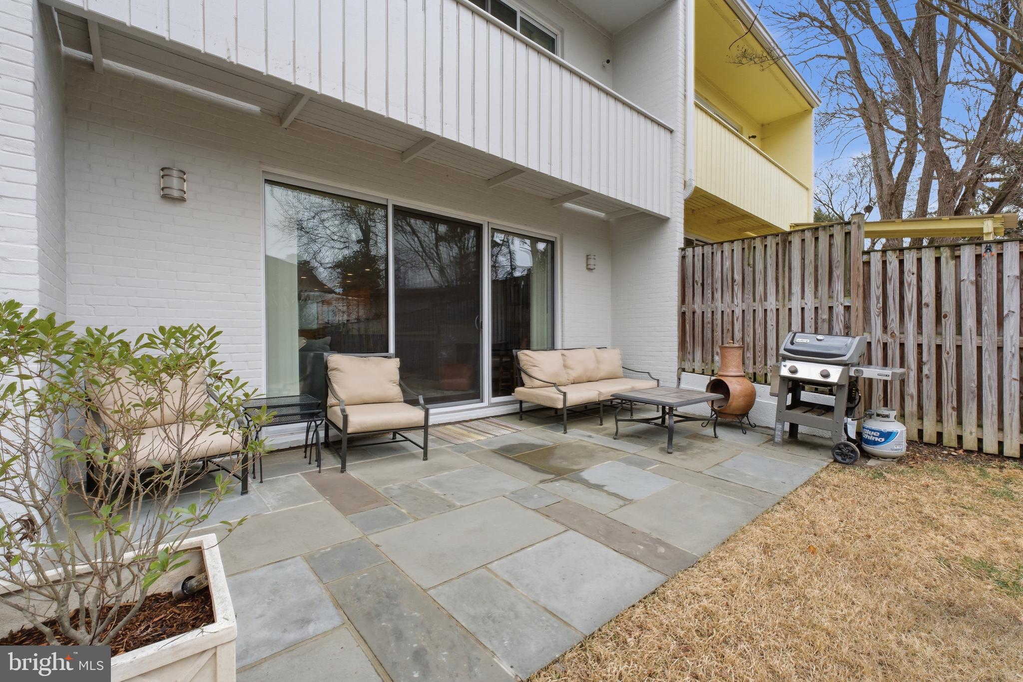 4848 Reservoir Road Northwest Washington, DC 20007 - Photo 36 of 49 a view of a patio with table and chairs and potted plants