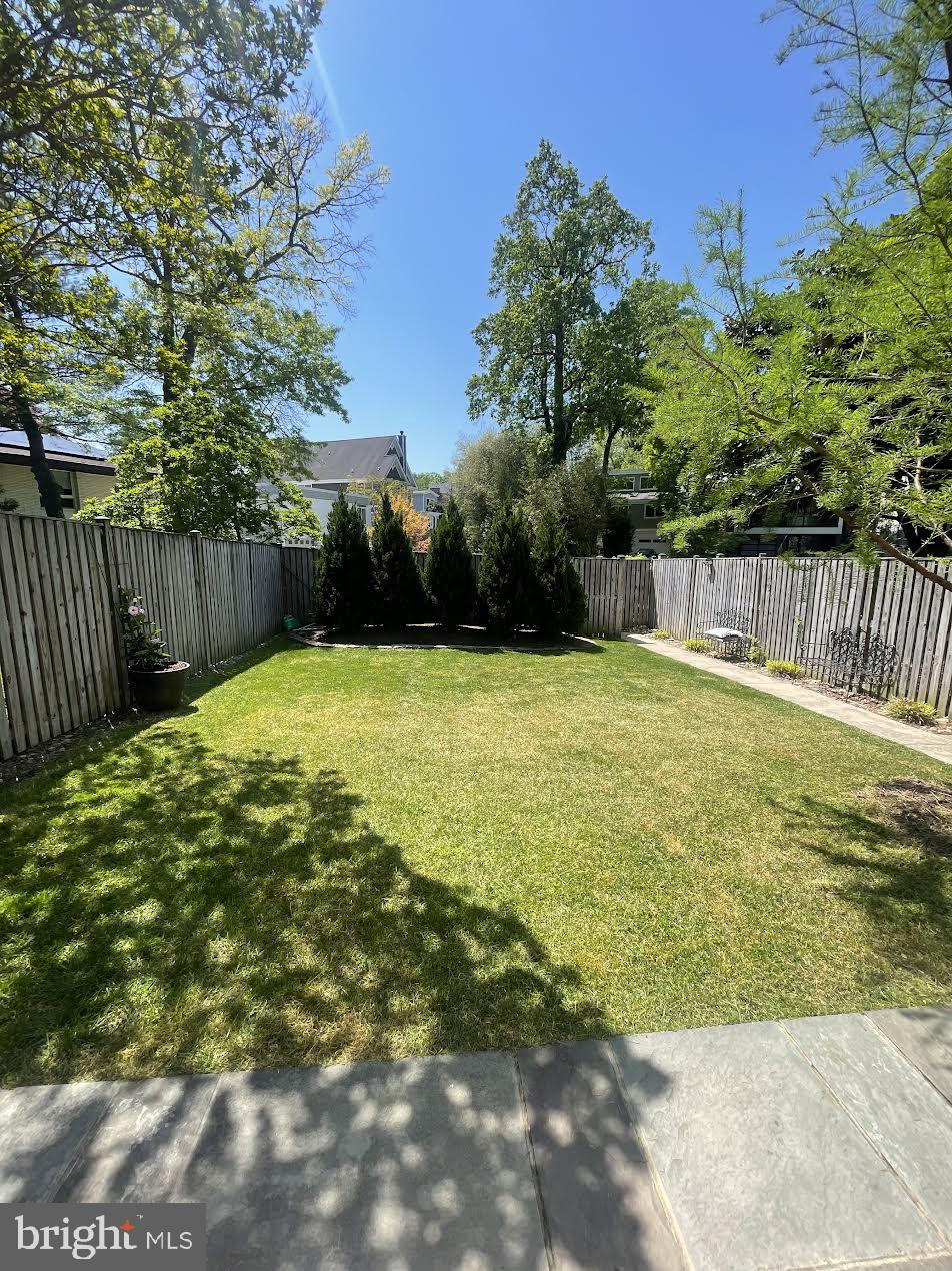 4848 Reservoir Road Northwest Washington, DC 20007 - Photo 37 of 49 a swimming pool with lawn chairs and wooden fence