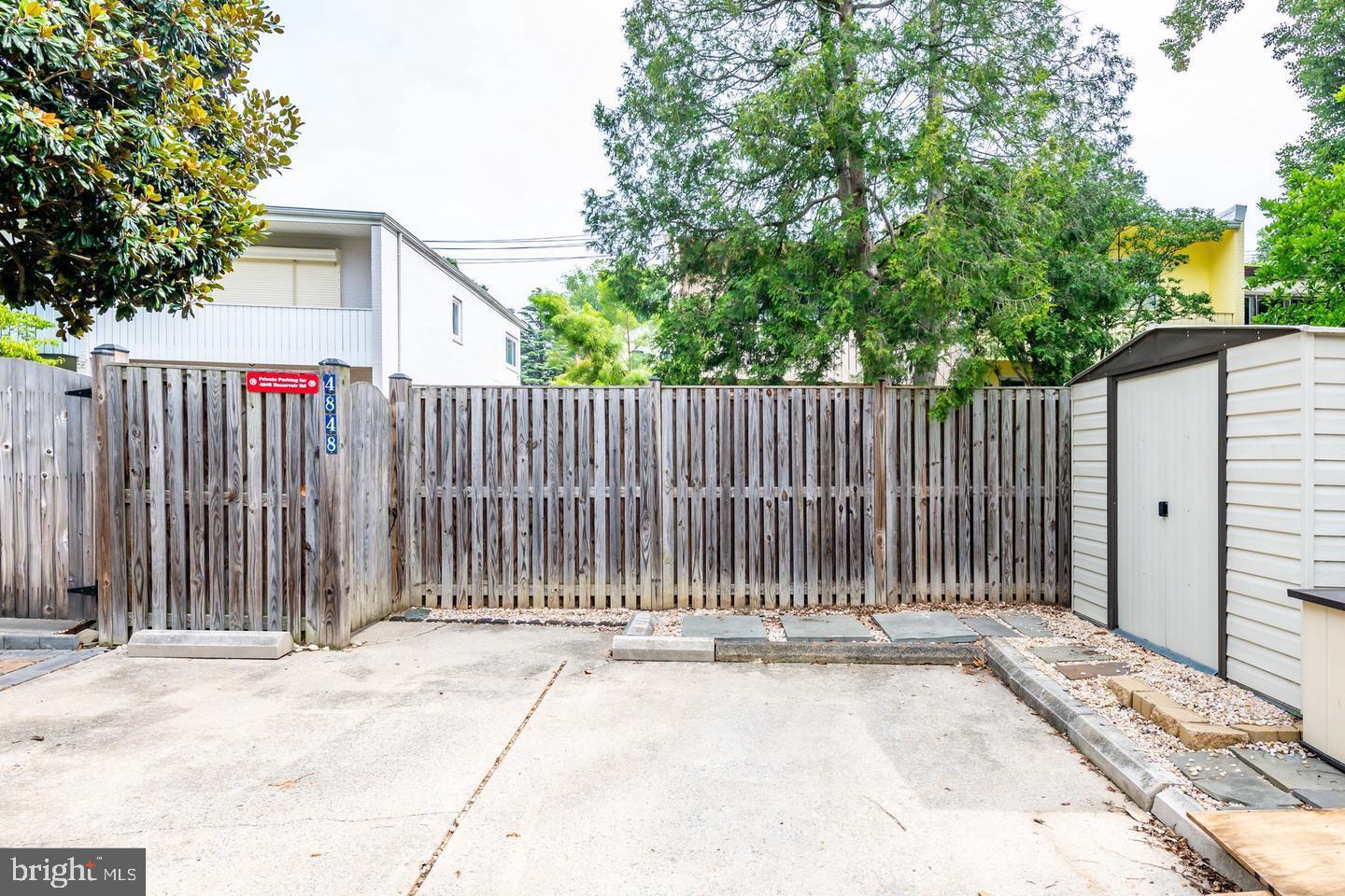 4848 Reservoir Road Northwest Washington, DC 20007 - Photo 42 of 49 a white house with a small yard and wooden fence