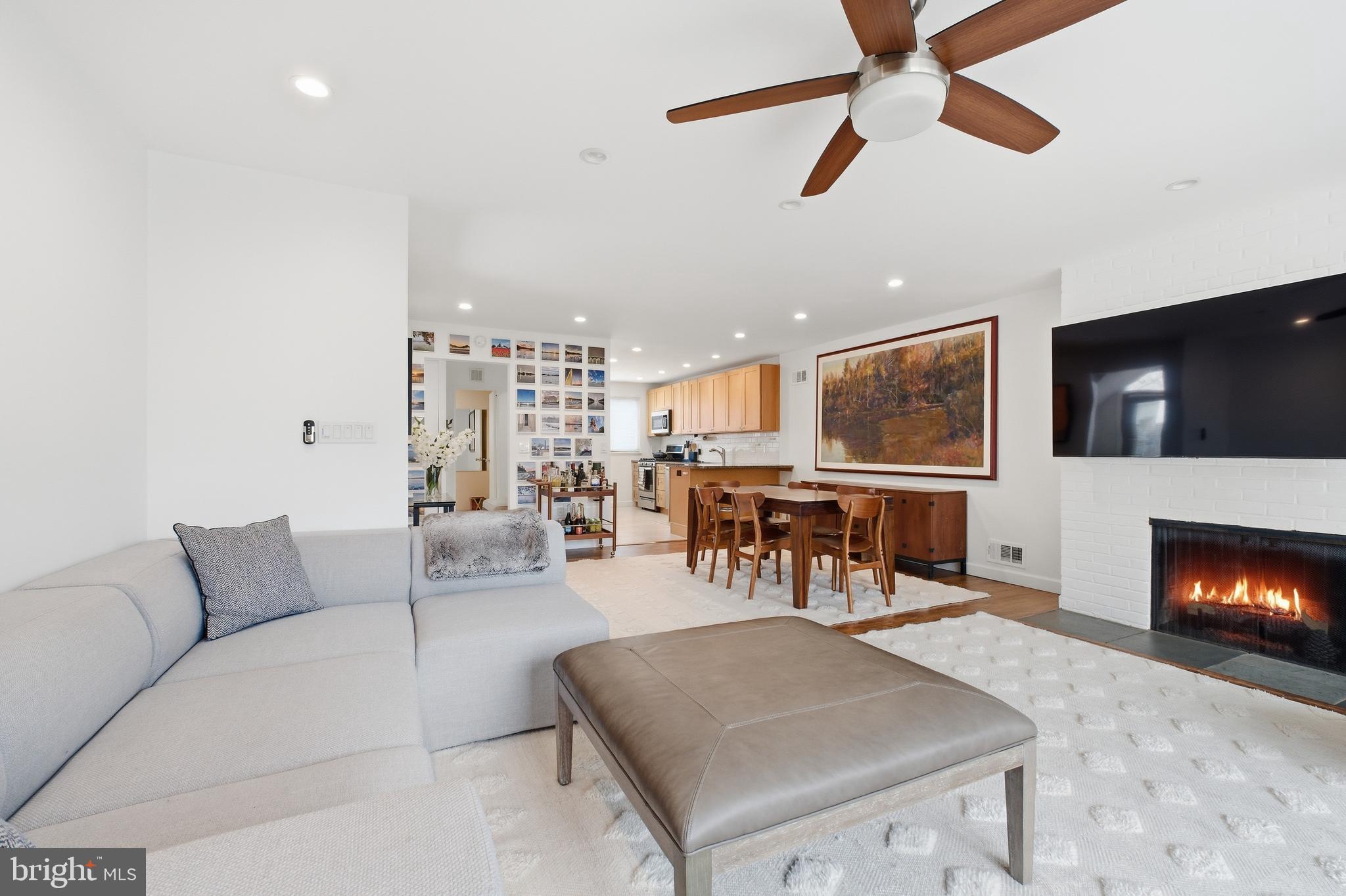 4848 Reservoir Road Northwest Washington, DC 20007 - Photo 5 of 49 a living room with furniture and a flat screen tv