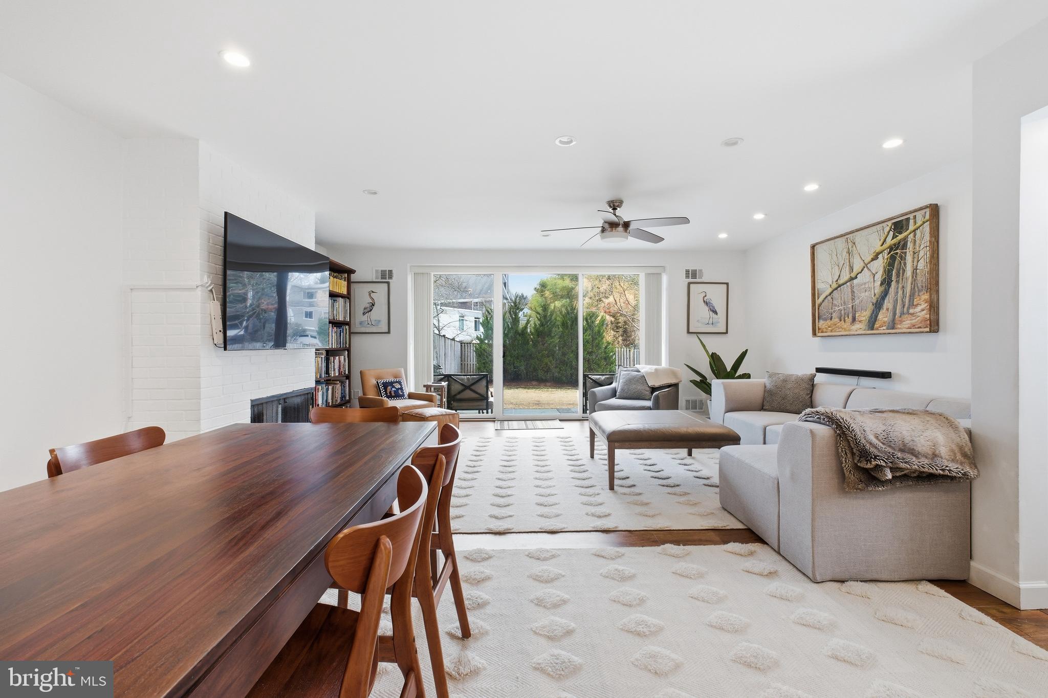 4848 Reservoir Road Northwest Washington, DC 20007 - Photo 7 of 49 a living room with fireplace furniture and a large window