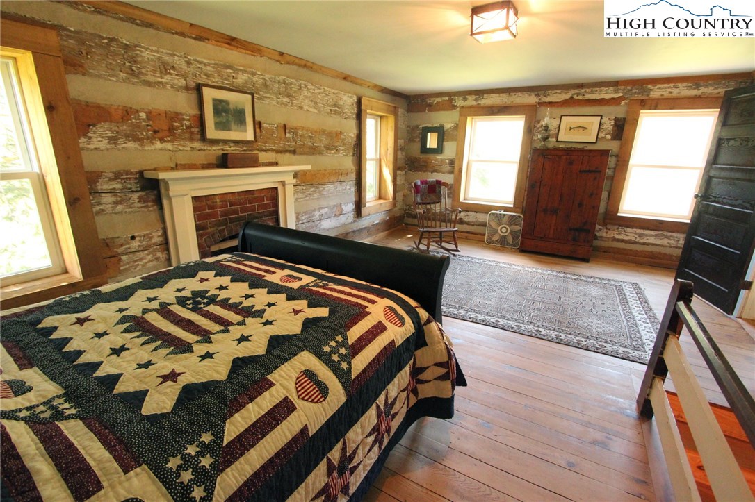 4513 Cedar Springs Road Speedwell, VA 24374 - Photo 26 of 49 a bedroom with a bed and wooden floor