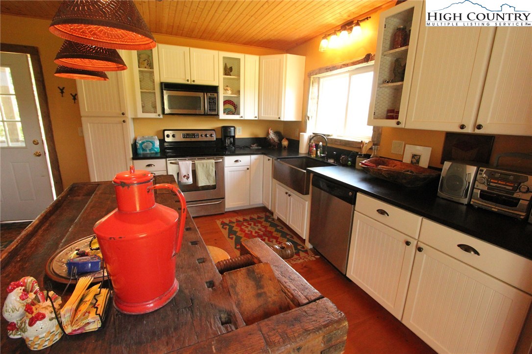 4513 Cedar Springs Road Speedwell, VA 24374 - Photo 8 of 49 a kitchen with stainless steel appliances granite countertop a stove a sink and a microwave