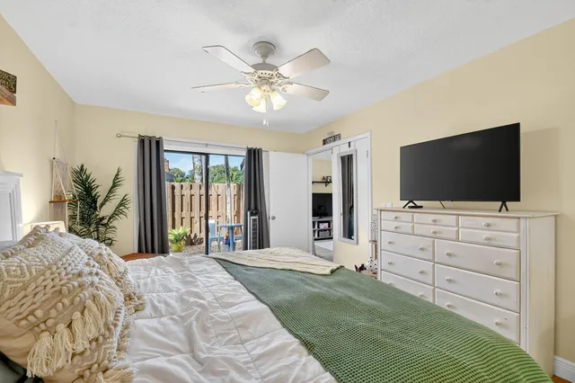 a bedroom with a bed and a flat screen tv