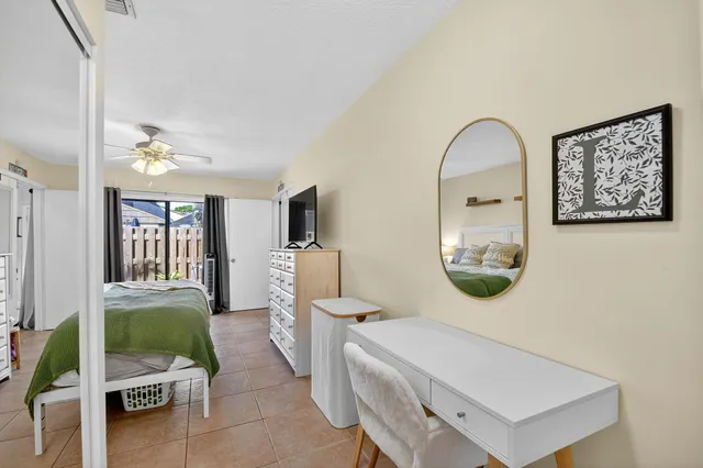 a living room with furniture a mirror and a table