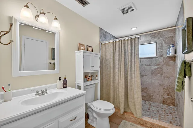a bathroom with a sink toilet and shower