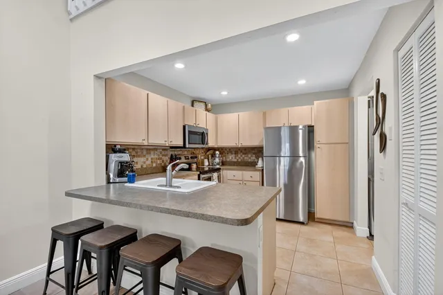 a kitchen with refrigerator and cabinets