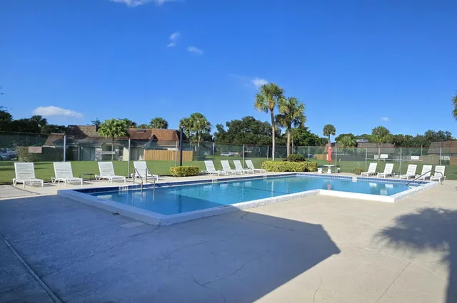 a view of a swimming pool and a yard