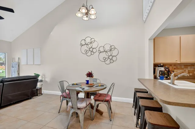 a view of a dining room with furniture and chandelier