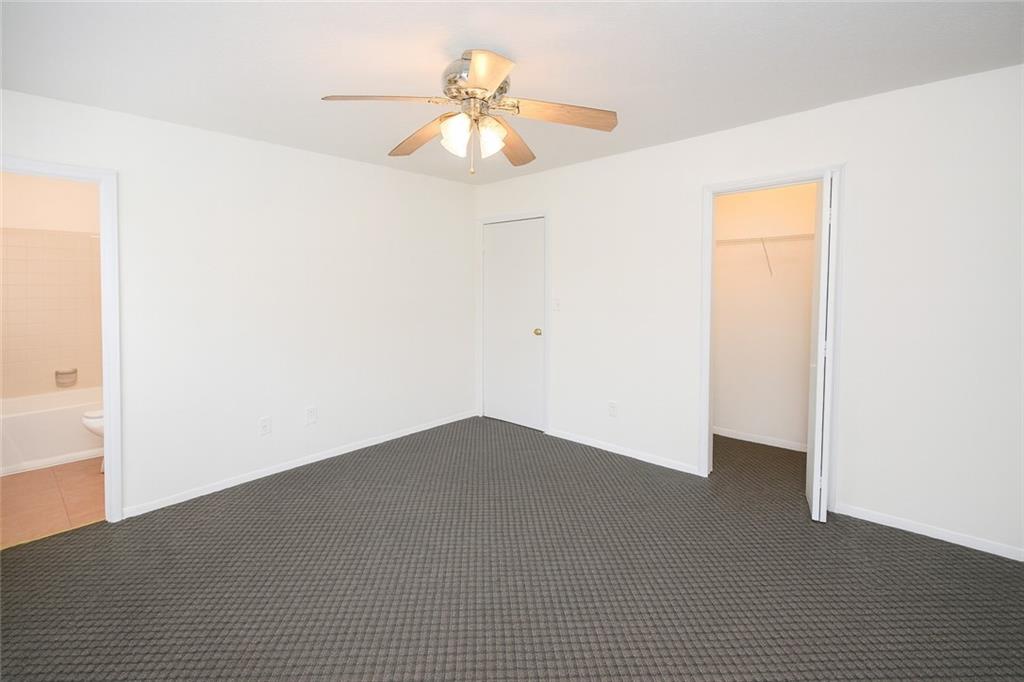 5328 Ridge Forest Drive Stone Mountain, GA 30083 - Photo 2 of 6 a view of a big room with closet and a chandelier fan