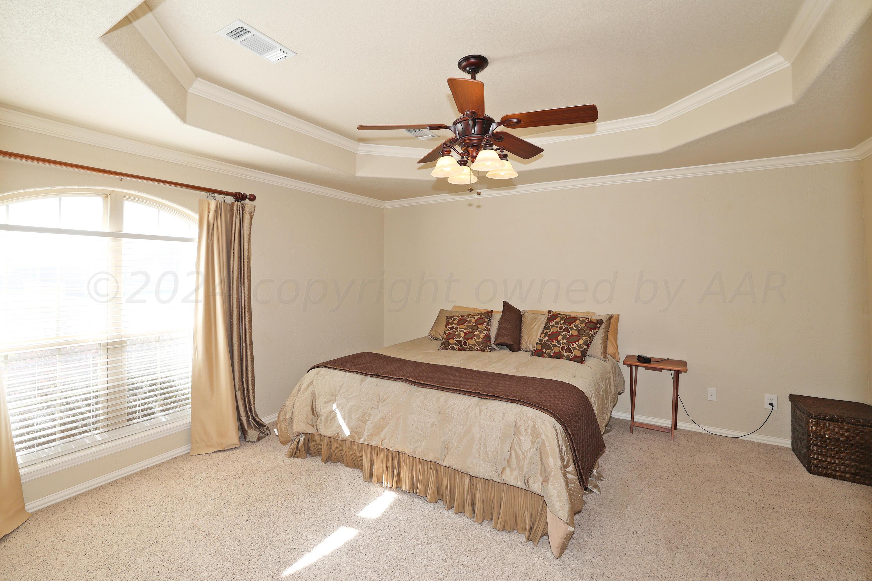 6902 Thunder Road Amarillo, TX 79119 - Photo 12 of 32 a bedroom with a large bed and a window