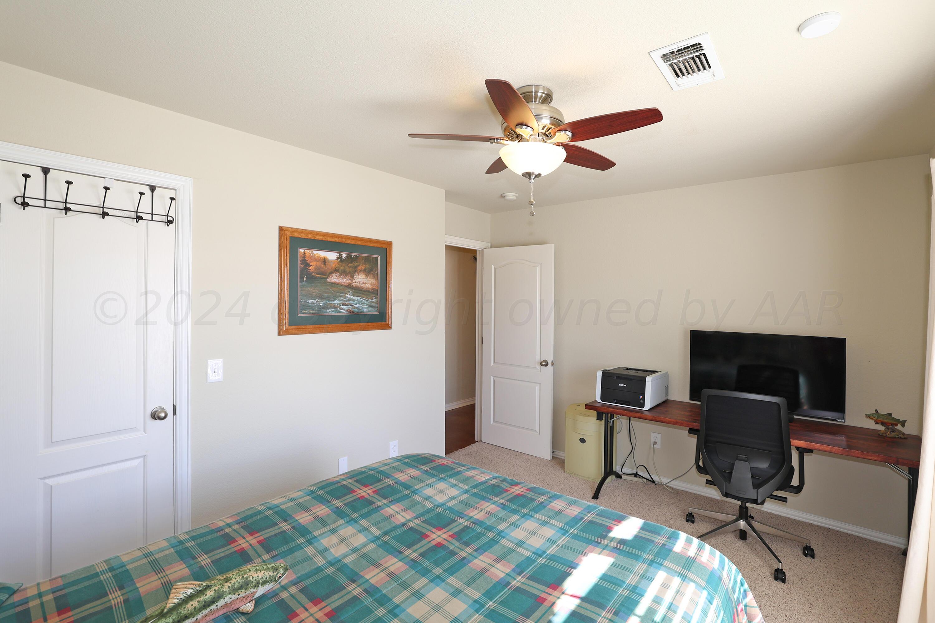 6902 Thunder Road Amarillo, TX 79119 - Photo 18 of 32 a bedroom with a workspace