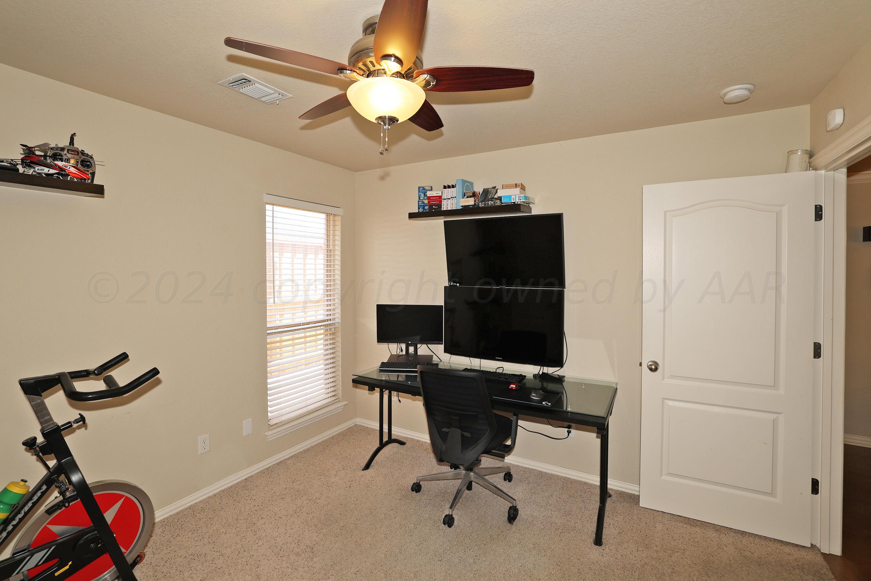 6902 Thunder Road Amarillo, TX 79119 - Photo 24 of 32 a view of a workspace with furniture and a window