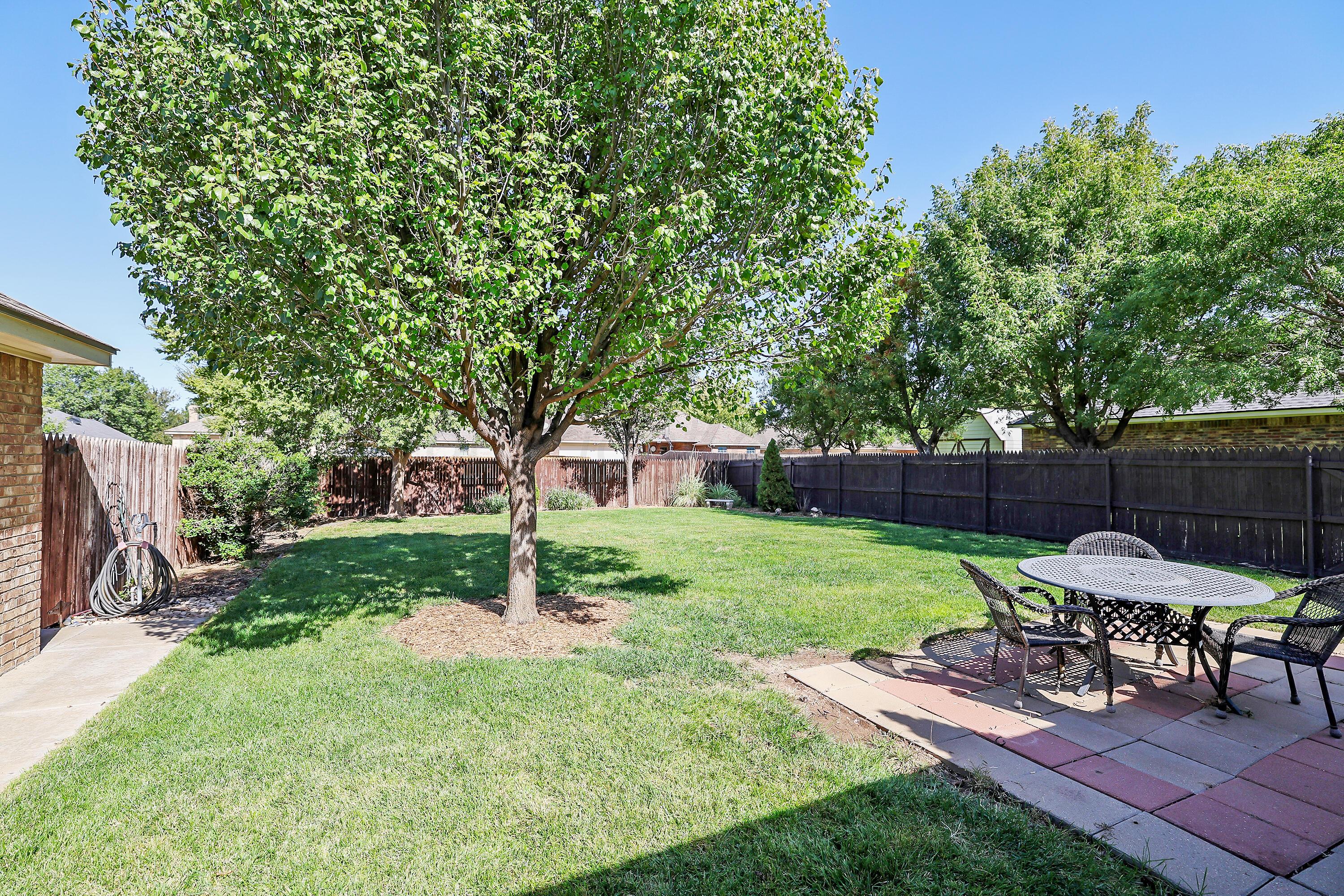 6902 Thunder Road Amarillo, TX 79119 - Photo 29 of 32 a view of a backyard with furniture and a slide