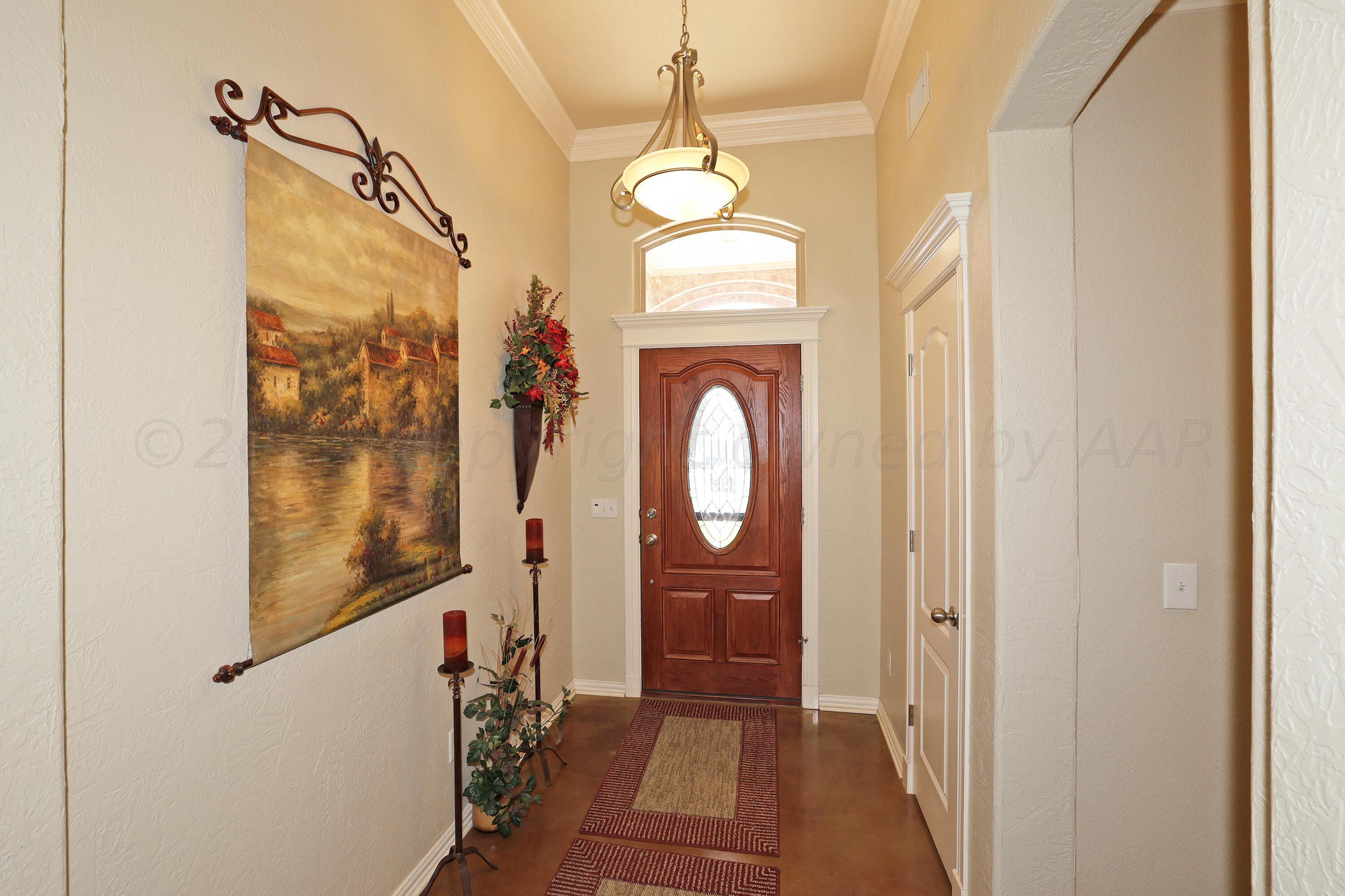 6902 Thunder Road Amarillo, TX 79119 - Photo 3 of 32 a view of a hallway with wooden floor and staircase