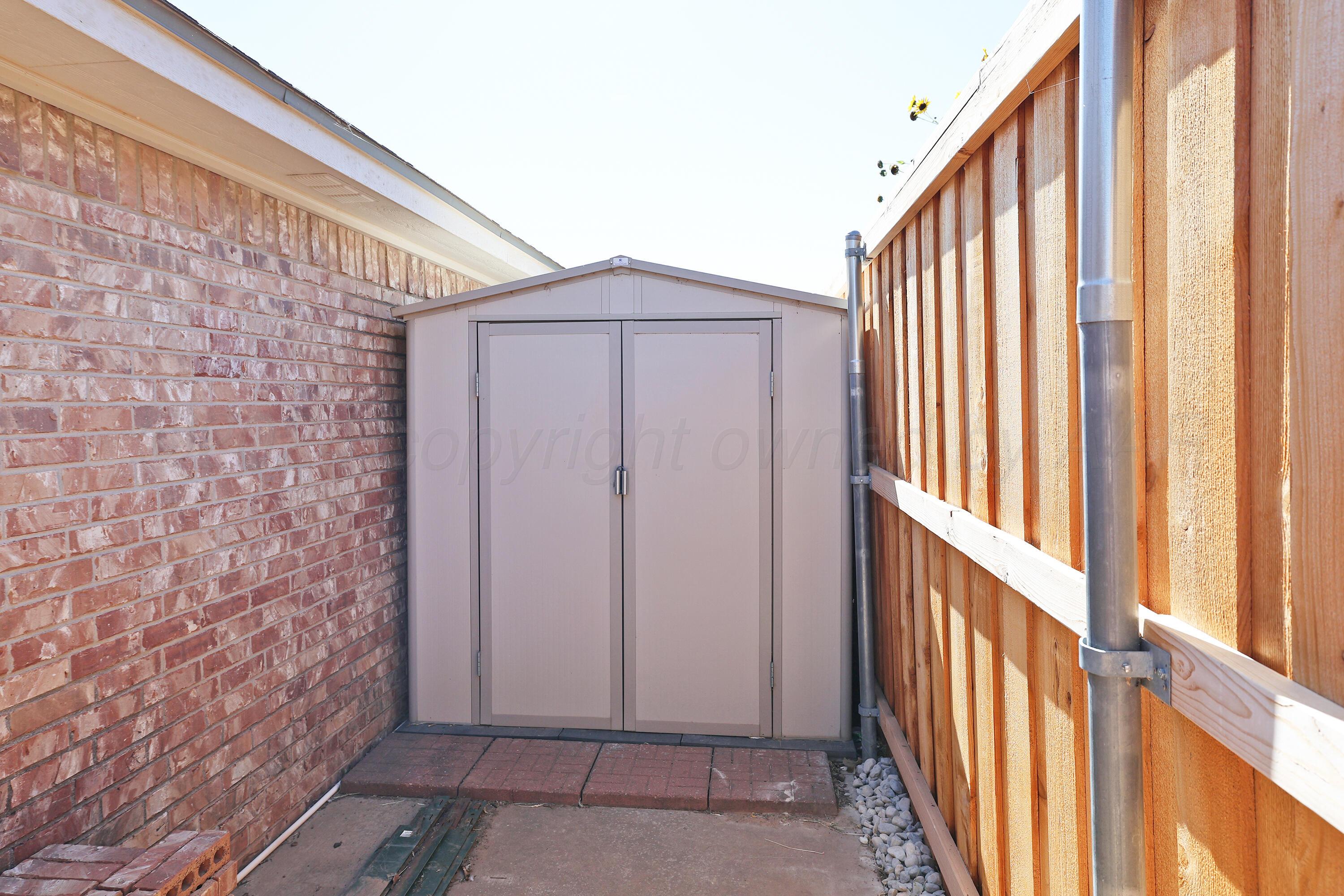 6902 Thunder Road Amarillo, TX 79119 - Photo 31 of 32 a view of a house with wooden floor and fence