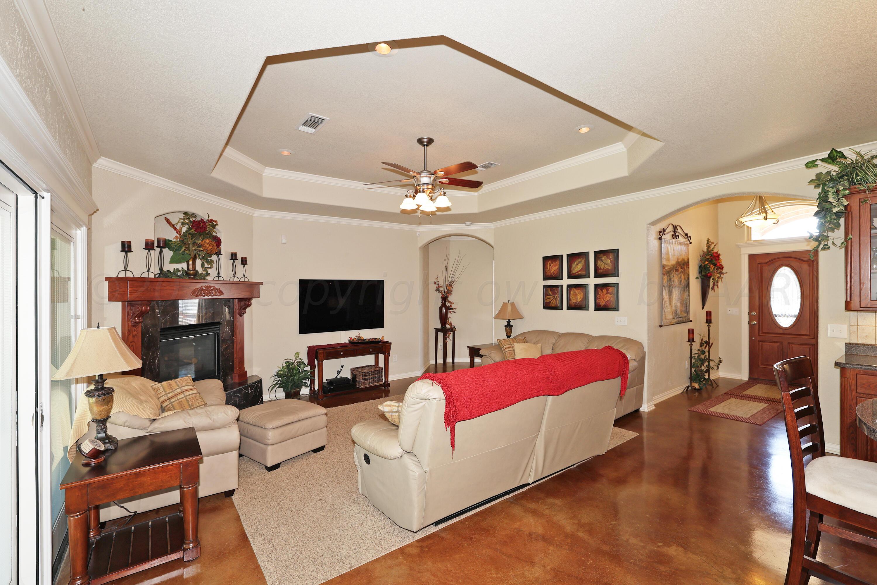 6902 Thunder Road Amarillo, TX 79119 - Photo 5 of 32 a living room with furniture and a flat screen tv