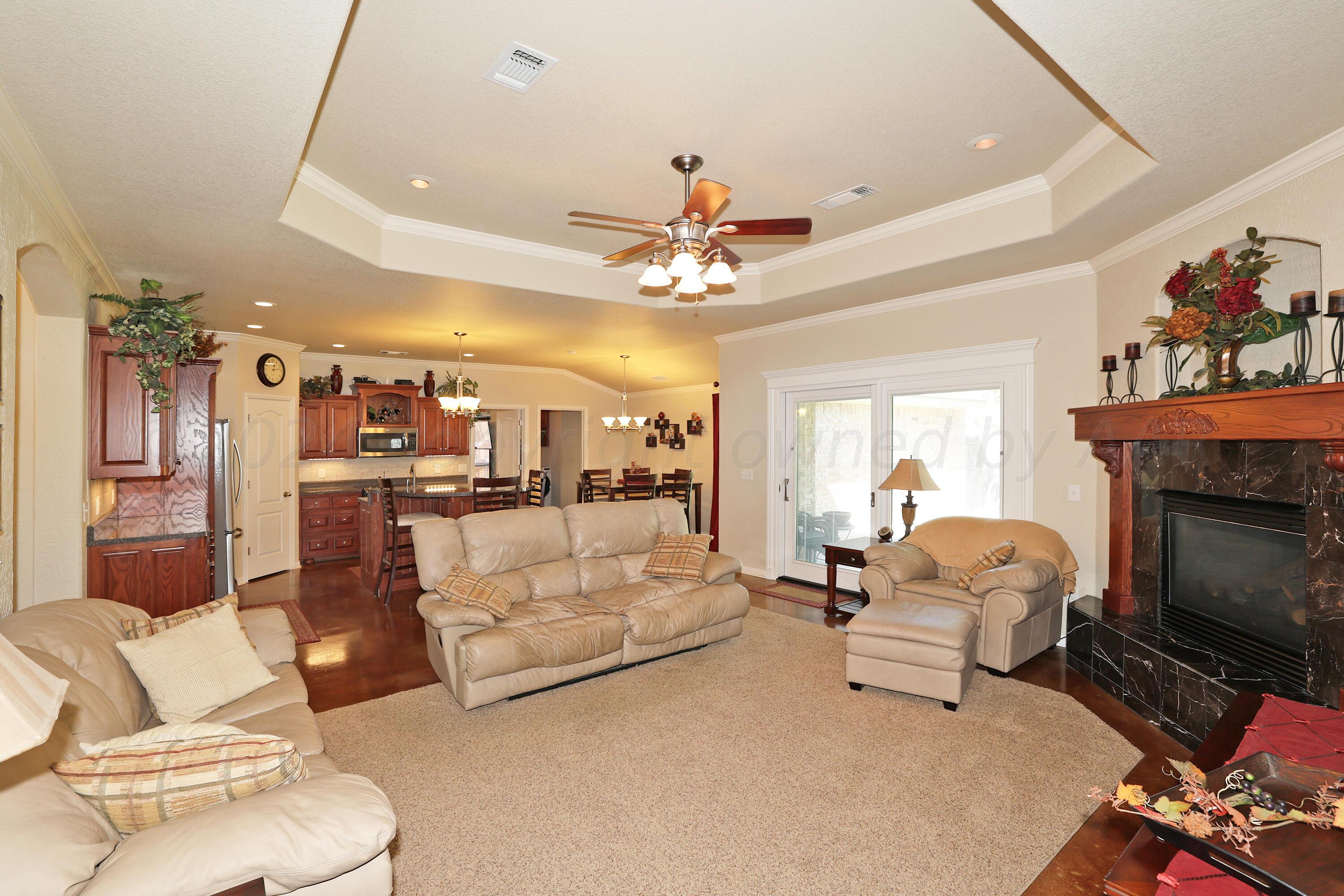 6902 Thunder Road Amarillo, TX 79119 - Photo 6 of 32 a living room with furniture and a fireplace