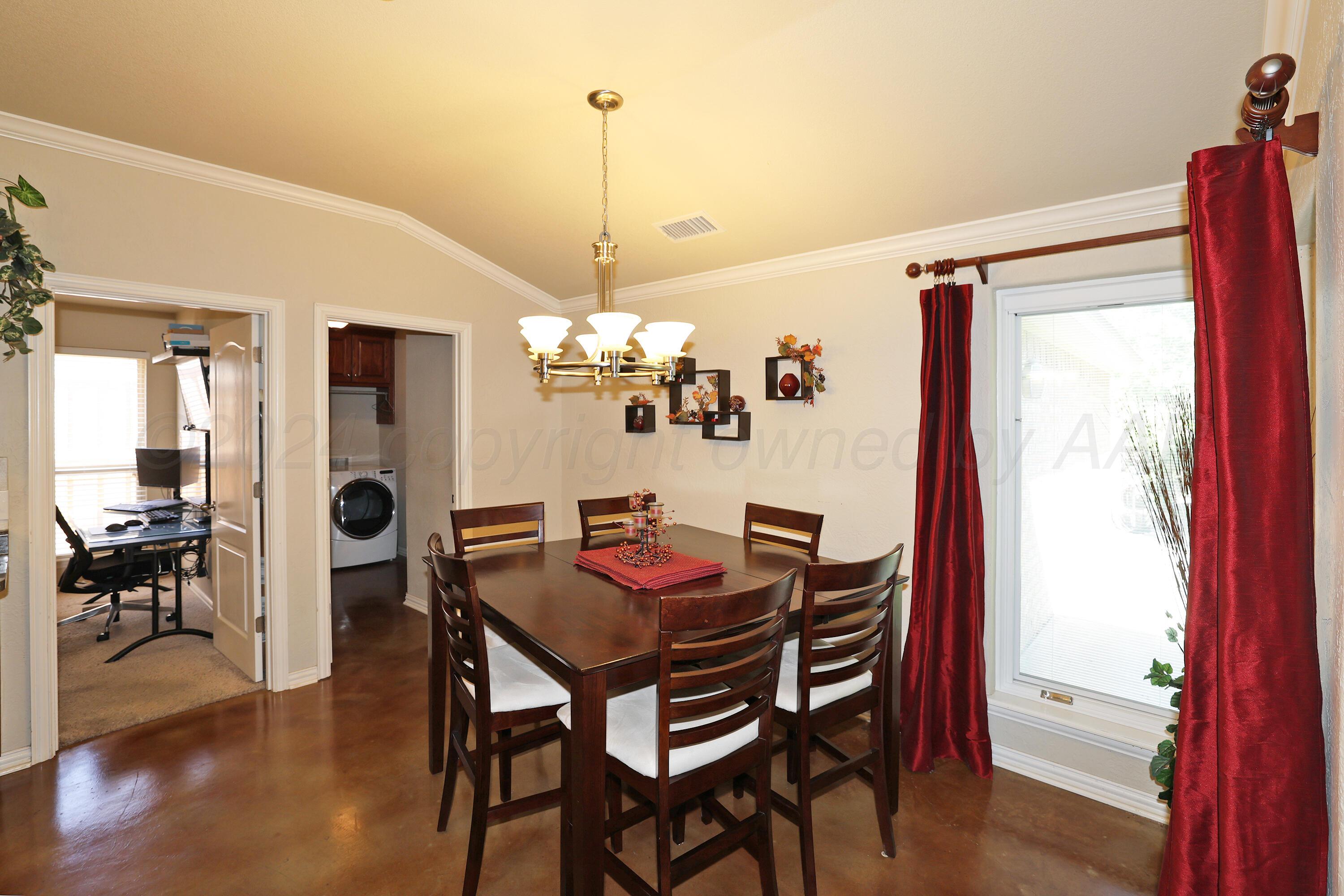6902 Thunder Road Amarillo, TX 79119 - Photo 7 of 32 a view of a dining room with furniture window and wooden floor