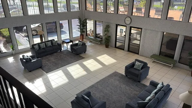 a living room with furniture fireplace and a window